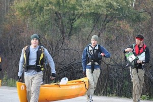 Sam fiddles with the map so that he doesn't have to carry the canoe.